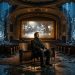 Man watching screen dissolving city 202605021355